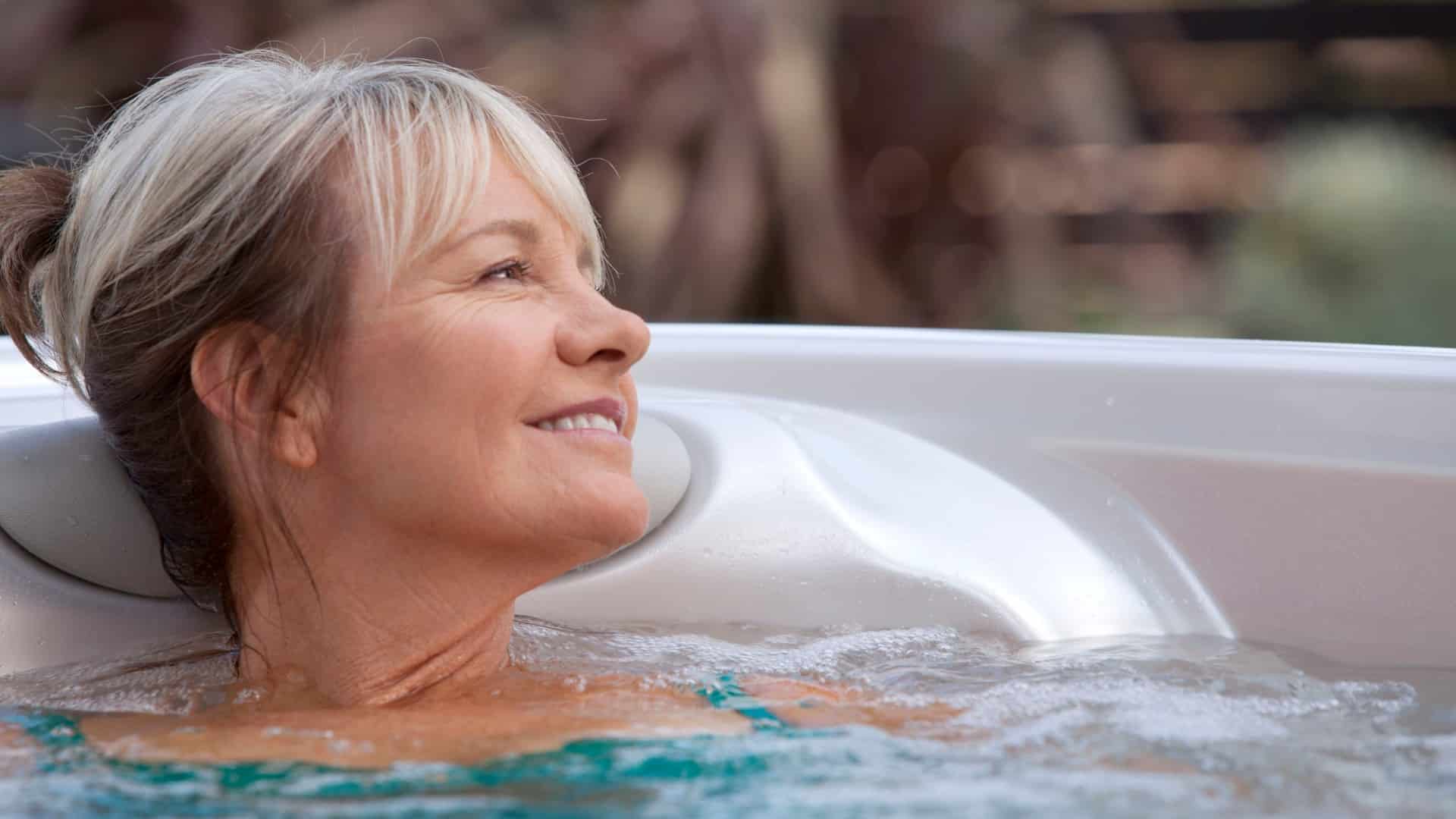 a woman relaxing in a hot tub because a new study eyes hot tubs for overweight women