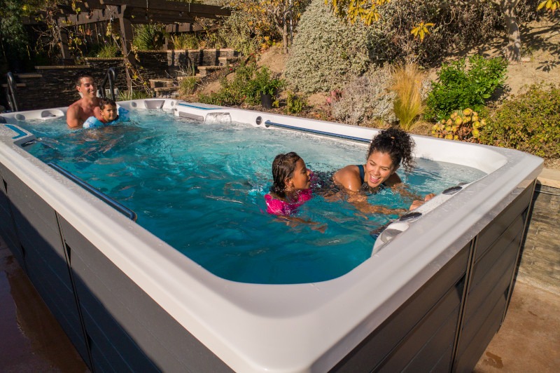 An Endless Pools® Swim Spa where a mother is teacher her daughter to swim.